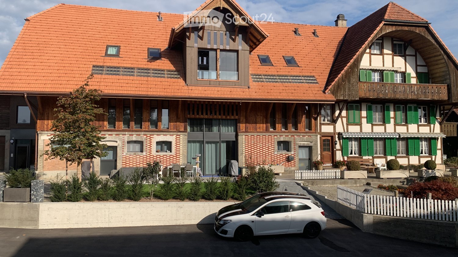 2 story house, orange roof, red brick, white window, wooden ground, balcony, garden