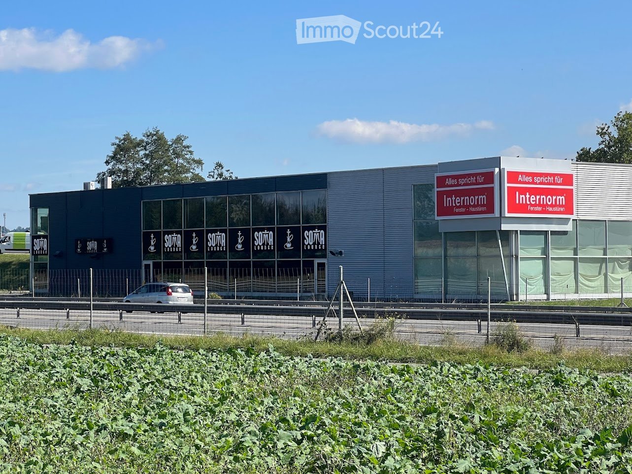 Modern commercial building with large glass windows and signage for "Internorm" and "Sötä Lounge".