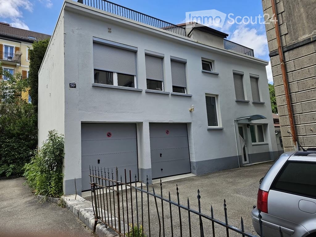 3-story house, white exterior, garage, fenced yard, balcony