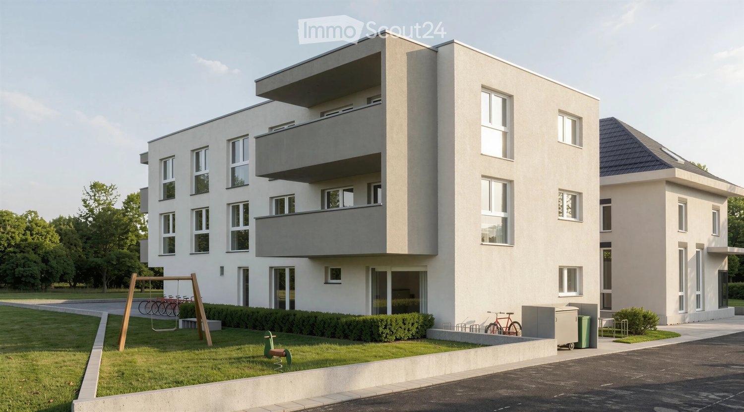 Modern two-story residential building with balconies, large windows, and a small playground area in front.