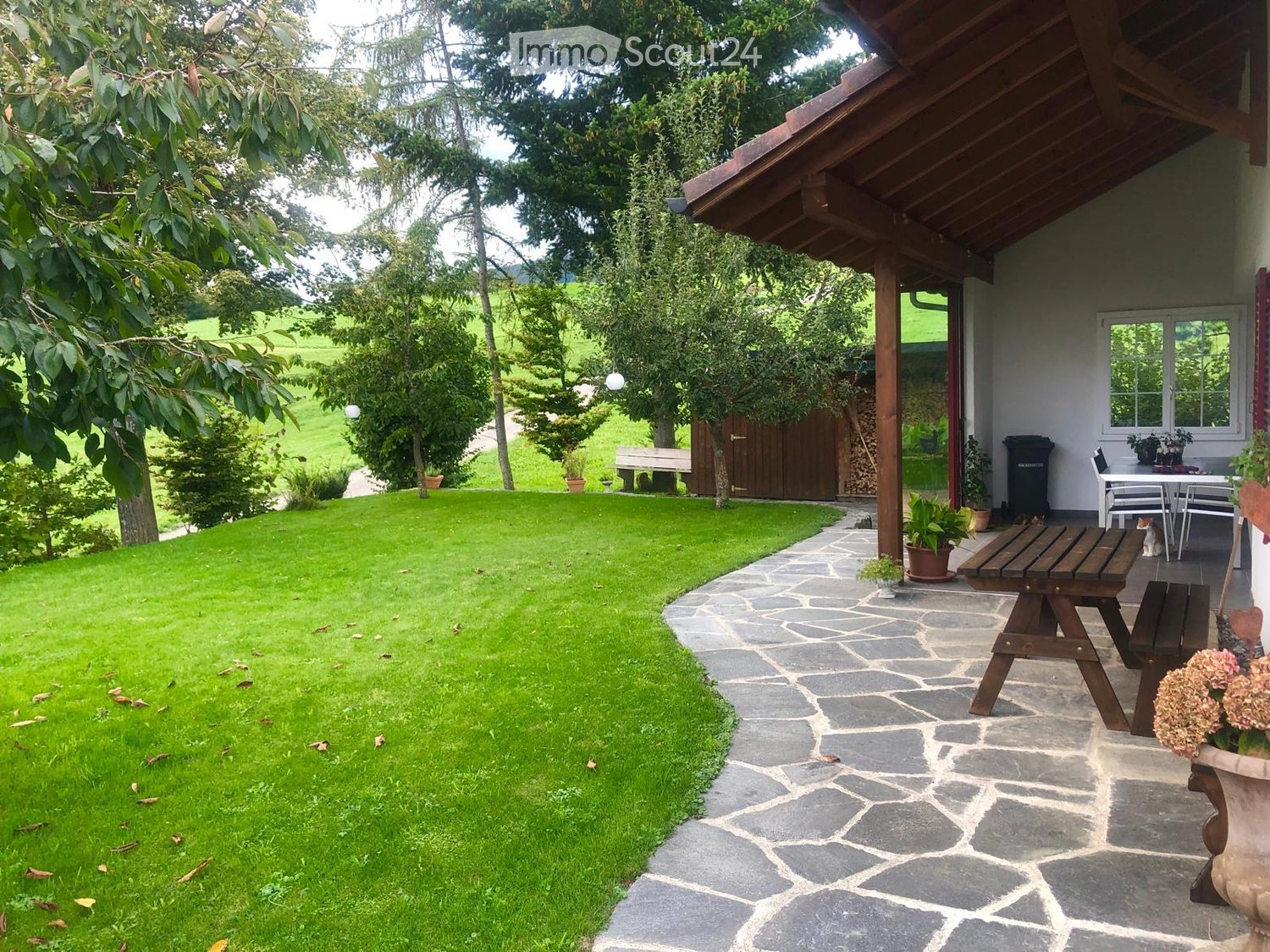 {"visible_features": ["Garden / Outdoor Area"], "type": "Garden / Outdoor Area", "objects": ["wooden bench", "wooden table", "wooden plant pot", "wooden plant pot", "wooden plant pot", "wooden plant pot", "wooden plant pot", "wooden plant pot", "wooden pl
