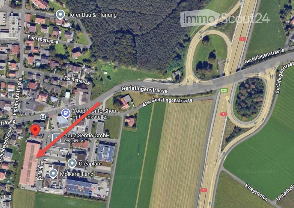 Aerial view of a residential area with a road intersection and surrounding farmland and greenery. The highlighted property is marked with a red arrow.