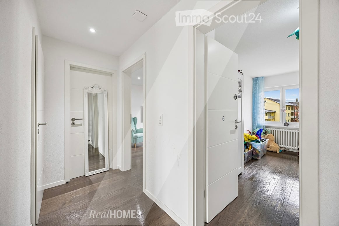 white walls, wooden floor, white doors, mirror, blue curtain, white radiator, toys