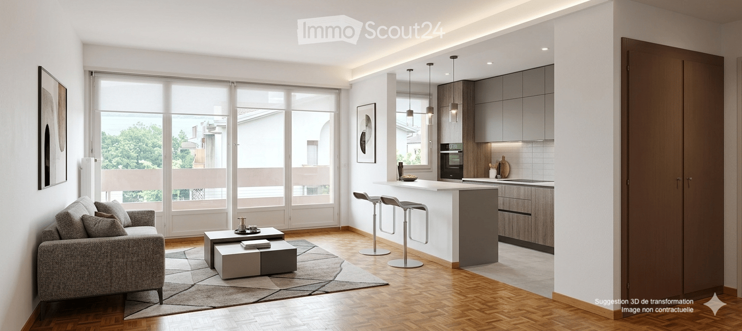 Modern open-plan living and dining area with a grey sofa, coffee table, and kitchen island. Large windows offer a view of greenery outside.