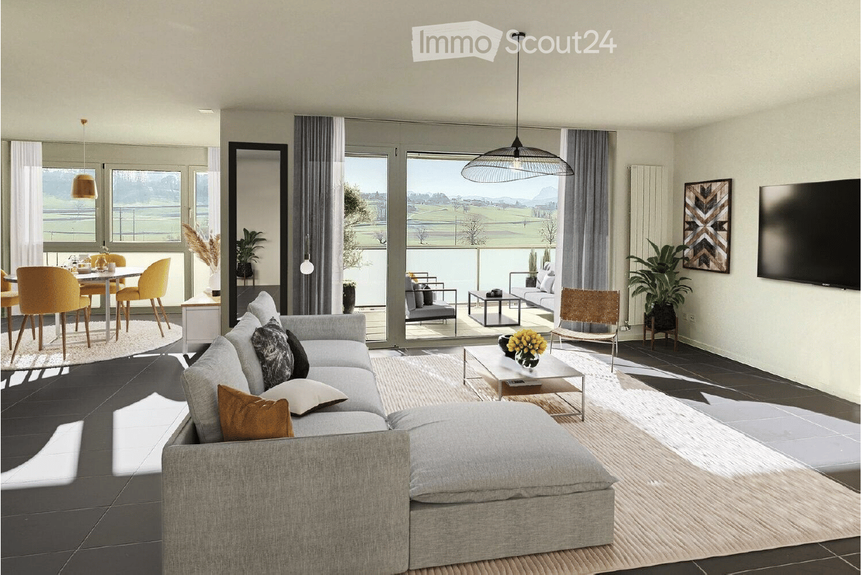 Modern living room with a grey sectional sofa, coffee table, dining area with yellow chairs, large windows offering a scenic view, and decorative plants.