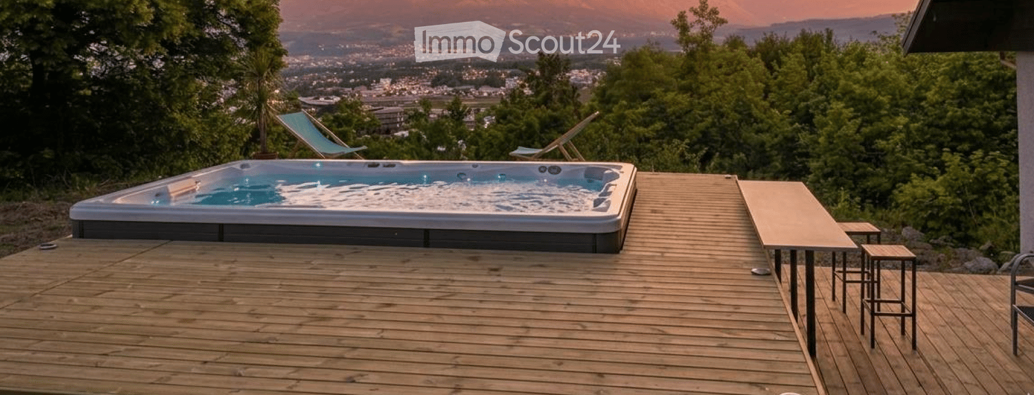 Wooden deck with a hot tub, lounge chairs, and a scenic city view.