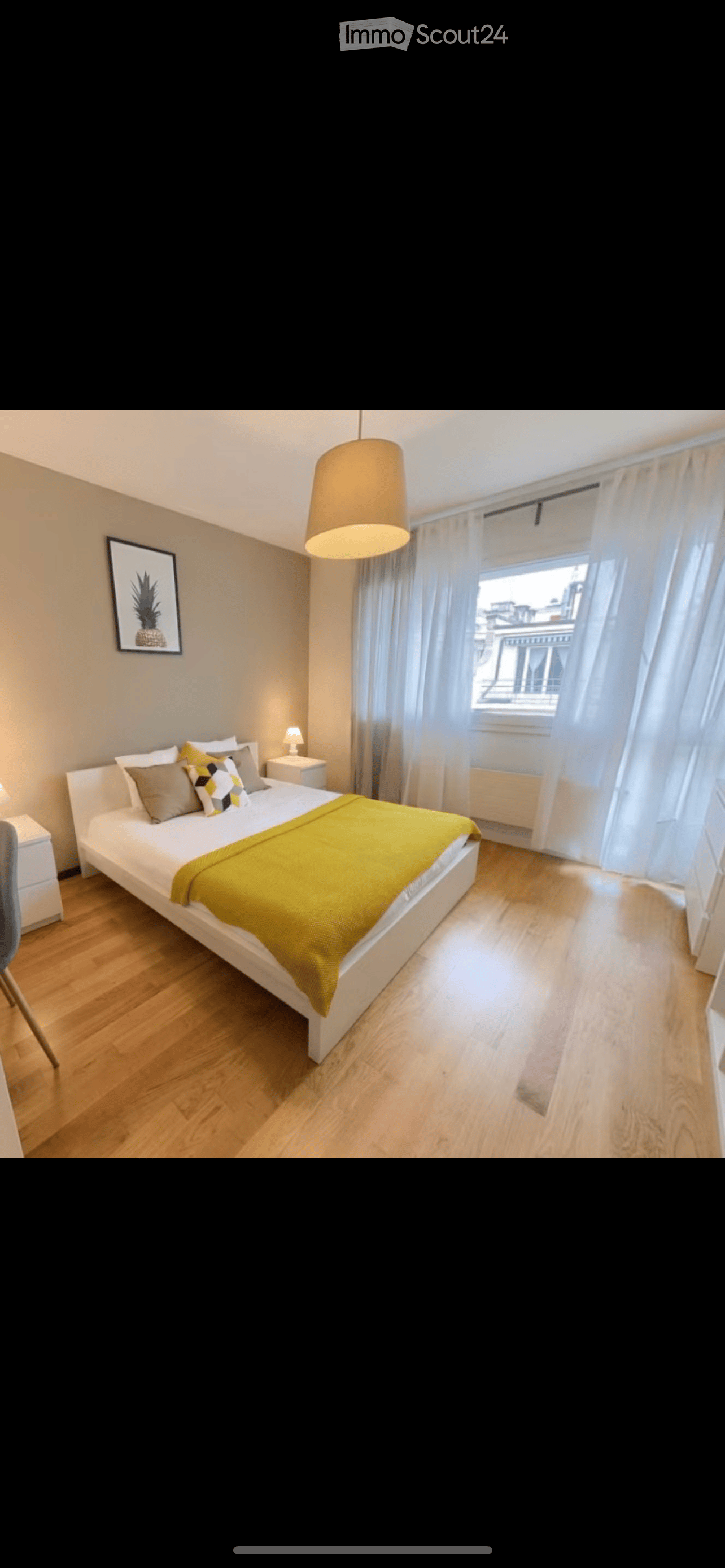 Modern bedroom with a white bed, yellow blanket, nightstand, chair, and large window with curtains.