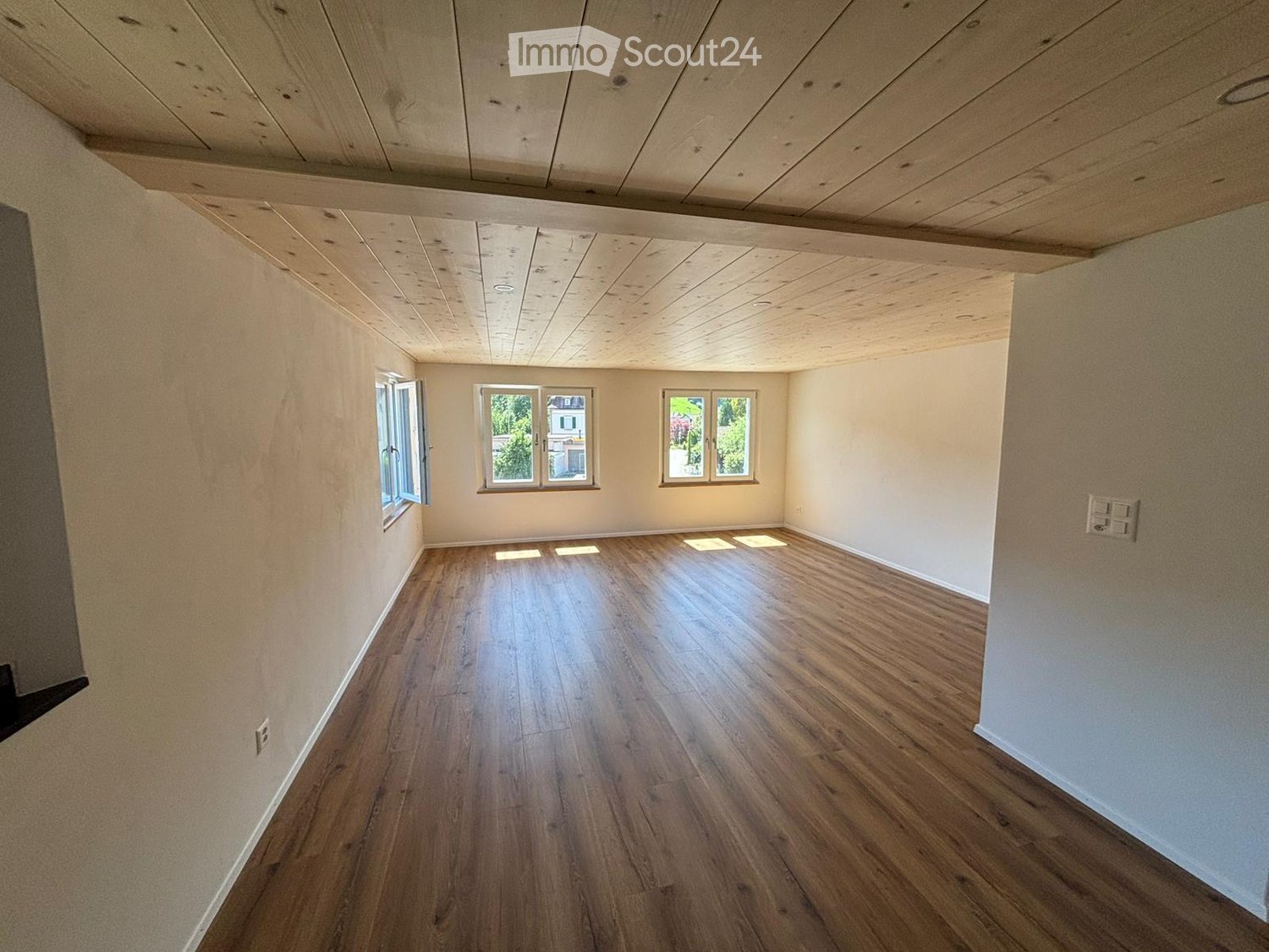empty room, hardwood floors, white walls, three windows, wooden ceiling