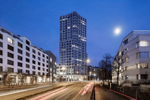 High-rise building, modern architecture, multiple windows, street lights, trees, road