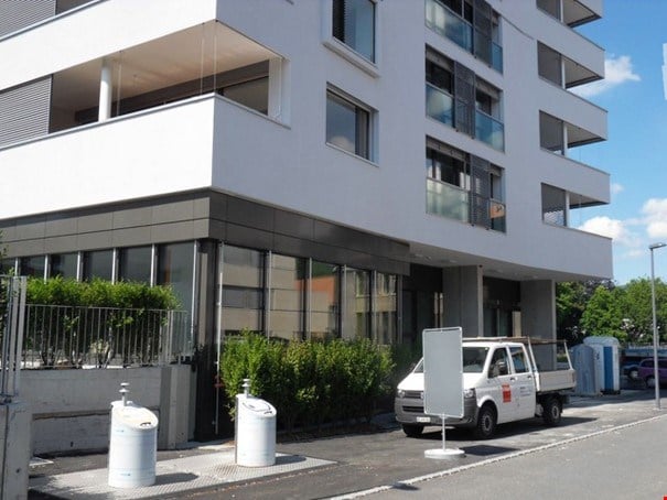 4 story white house, many windows, balcony, parking place