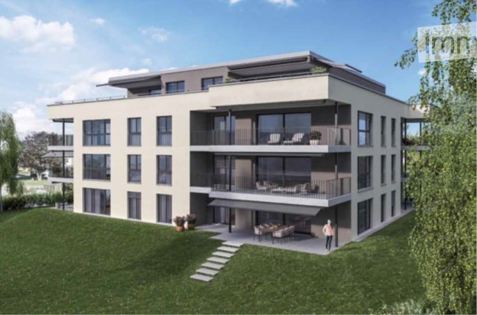 Modern multi-story residential building with balconies, large windows, and a landscaped lawn area.