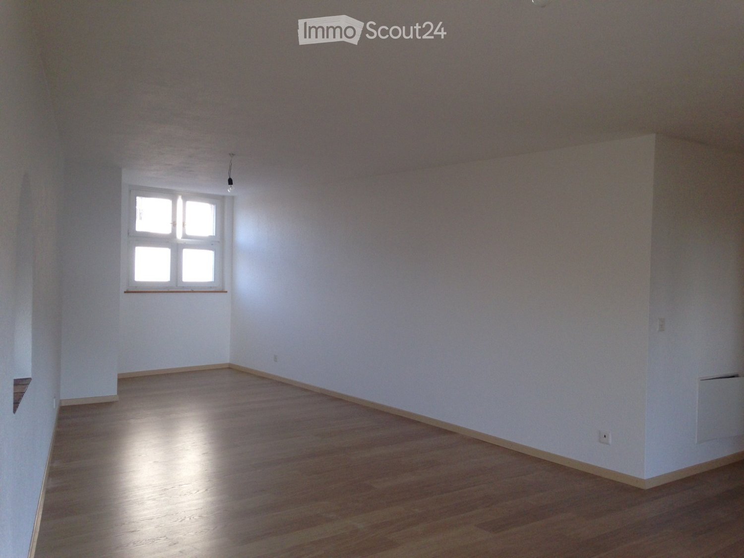 empty room, white walls, wooden floor, window, power outlets