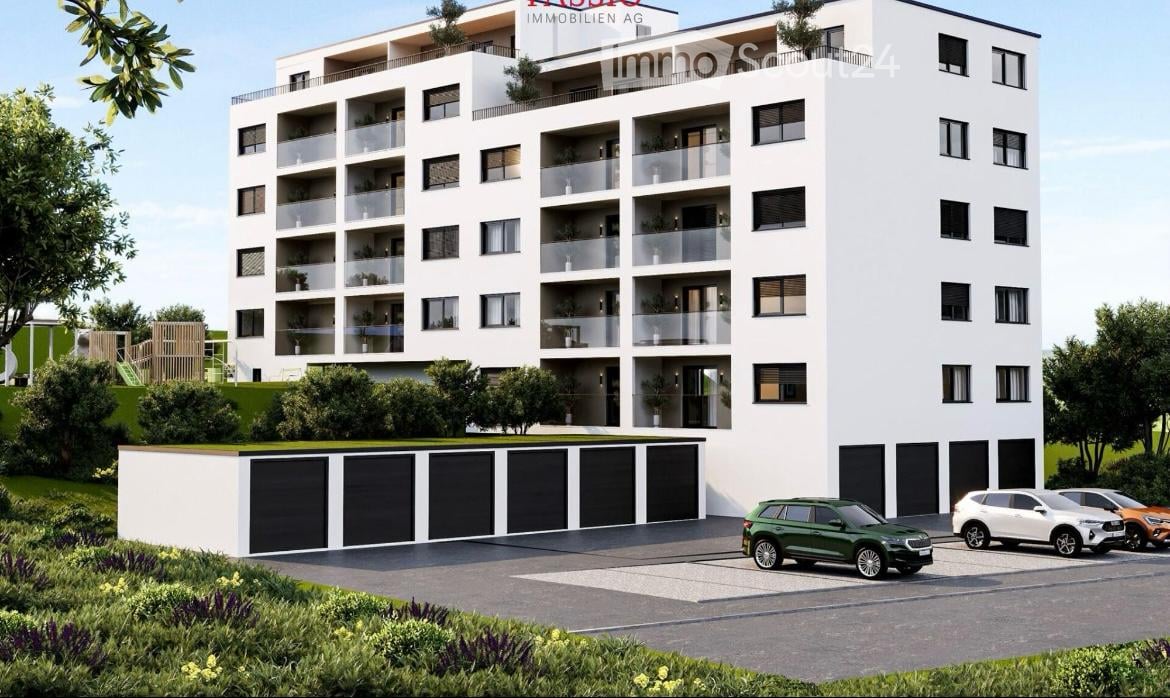 Modern multi-story residential building with balconies, garage, and parking area.