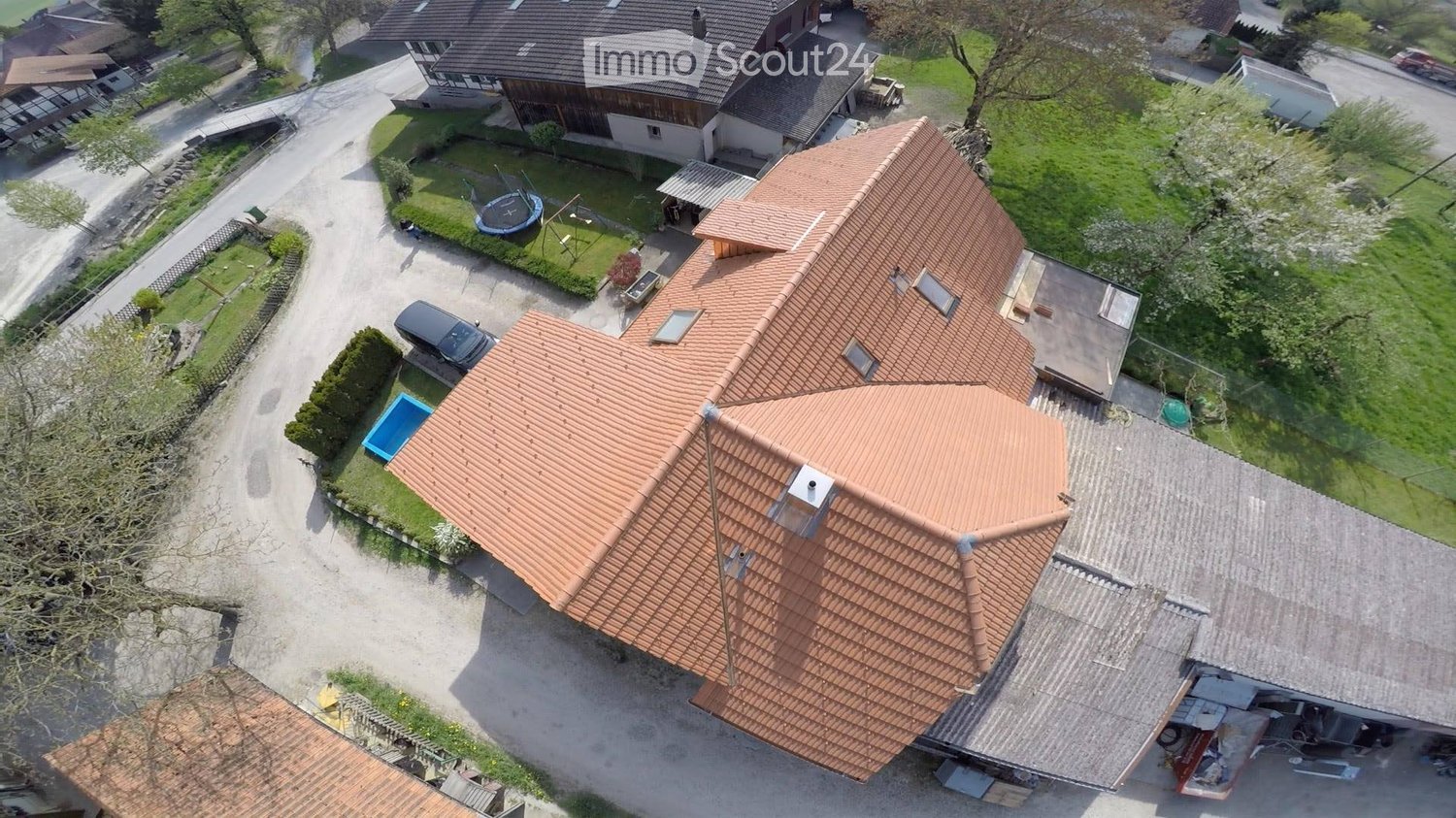 Modern two story house, red roof, outdoor swimming pool