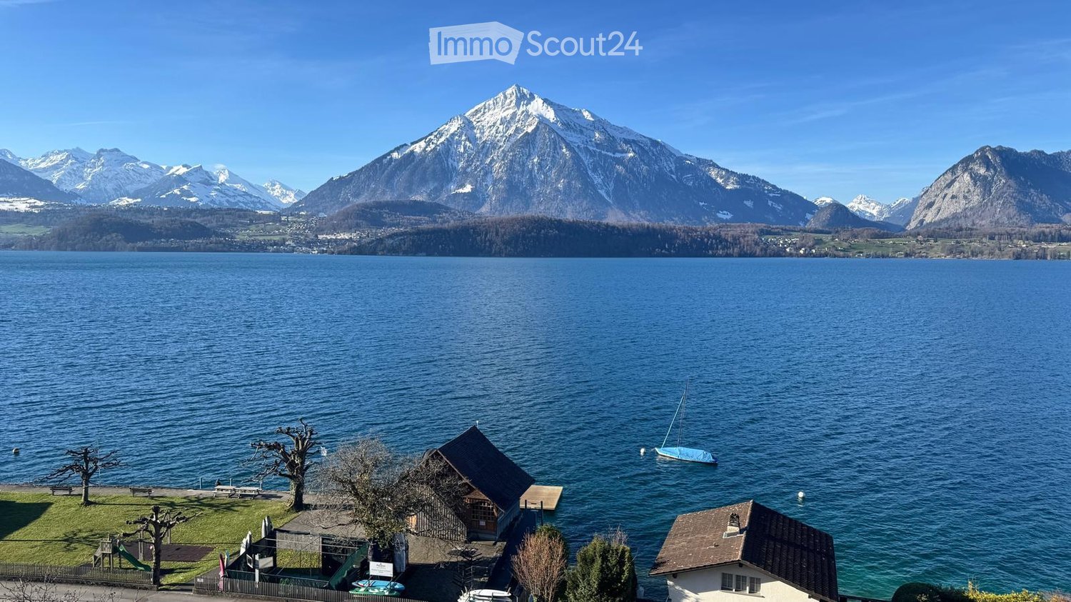 lake, mountains, small house, boat, trees, benches, slide