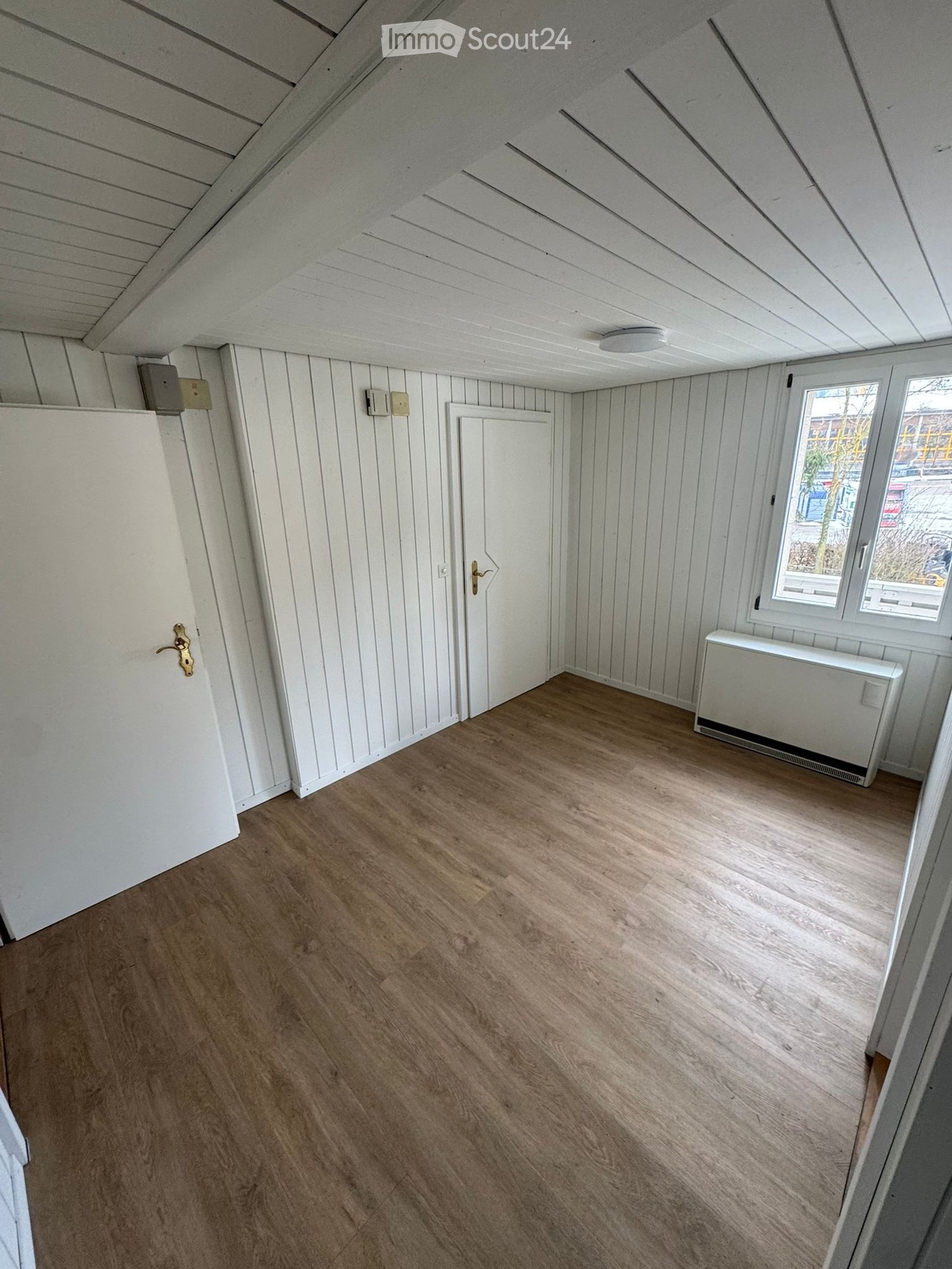 empty room, white walls, wooden floors, windows, wooden doors, light fixture