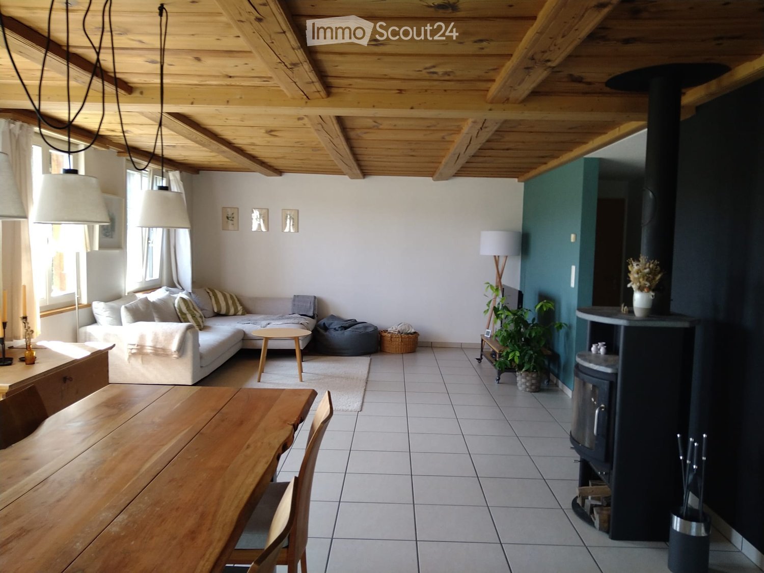 {"type": "Furnished Room", "objects": ["sofa", "table", "chair", "floor lamp", "wooden ceiling", "wooden dining table", "wooden chair", "wooden side table", "wooden cabinet", "wooden floor", "wooden wall", "wooden fireplace", "wooden plant stand", "wooden