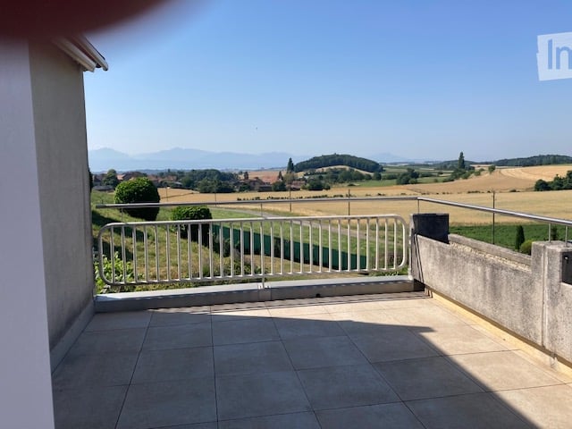 Balcony with tiled floor, metal railing, and scenic countryside view.