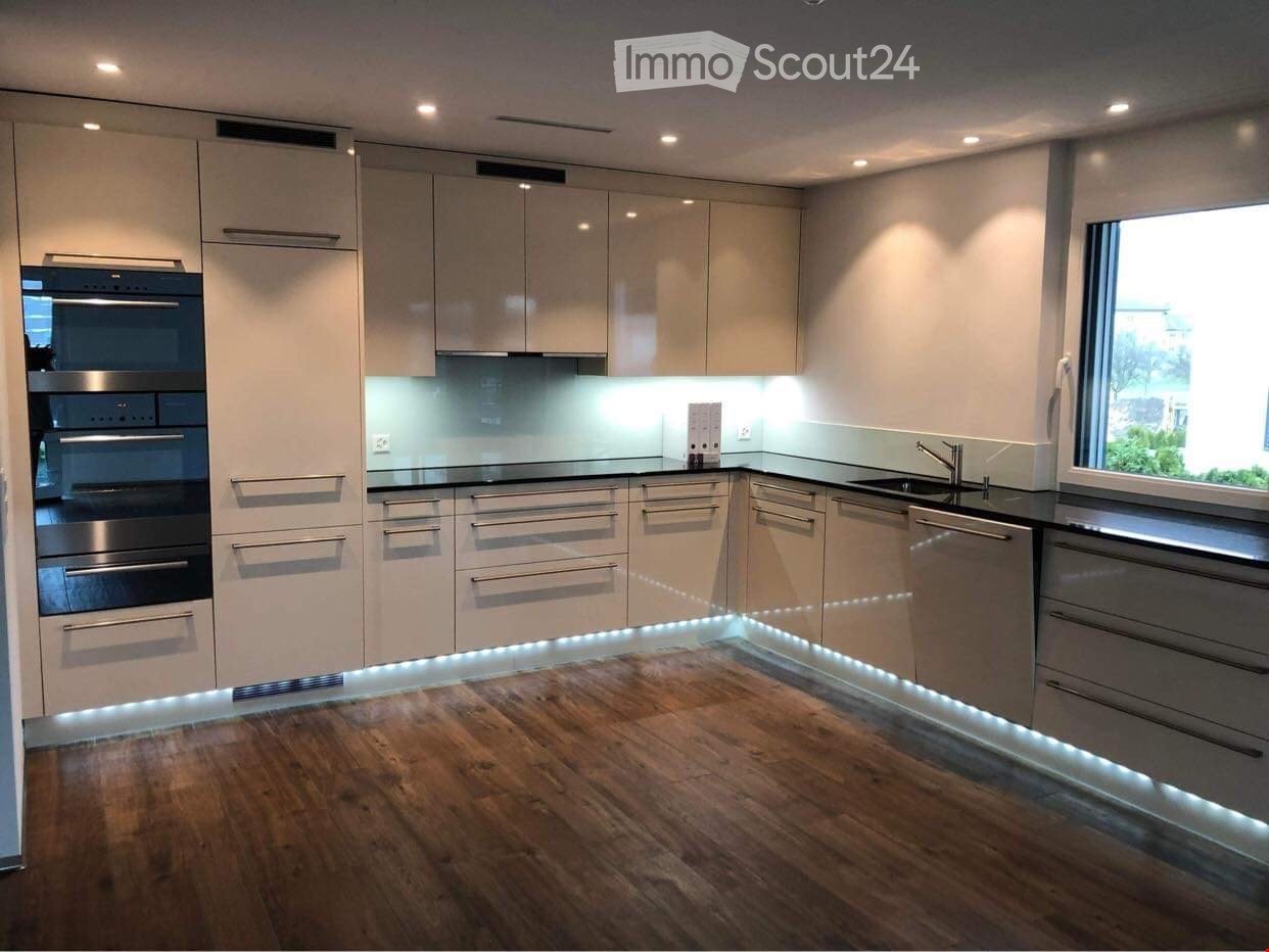 modern kitchen, stainless steel appliances, LED lighting, wooden floors, white cabinets, marble countertop