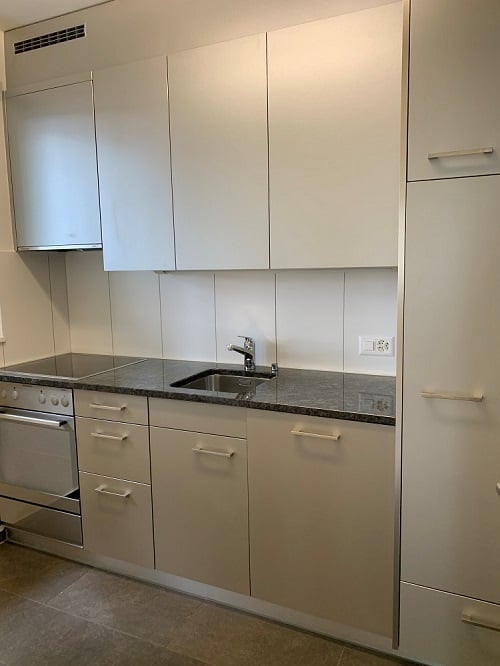 modern kitchen with white cabinets, granite countertop, stainless steel sink, gas stove, dishwasher, power outlet