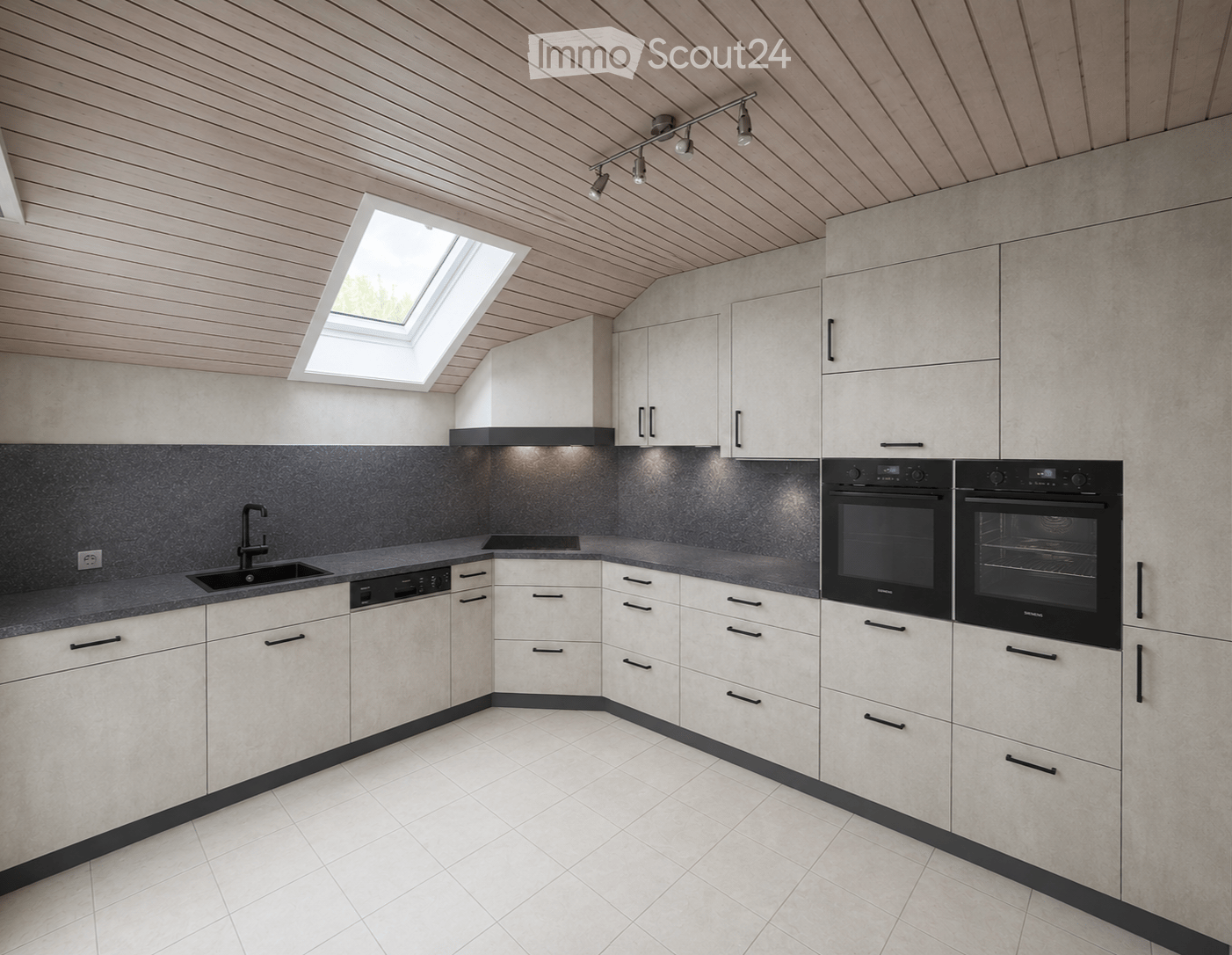 Modern kitchen with white cabinets, dark countertops, and built-in appliances including a dishwasher and oven. Features a skylight window and sleek track lighting.