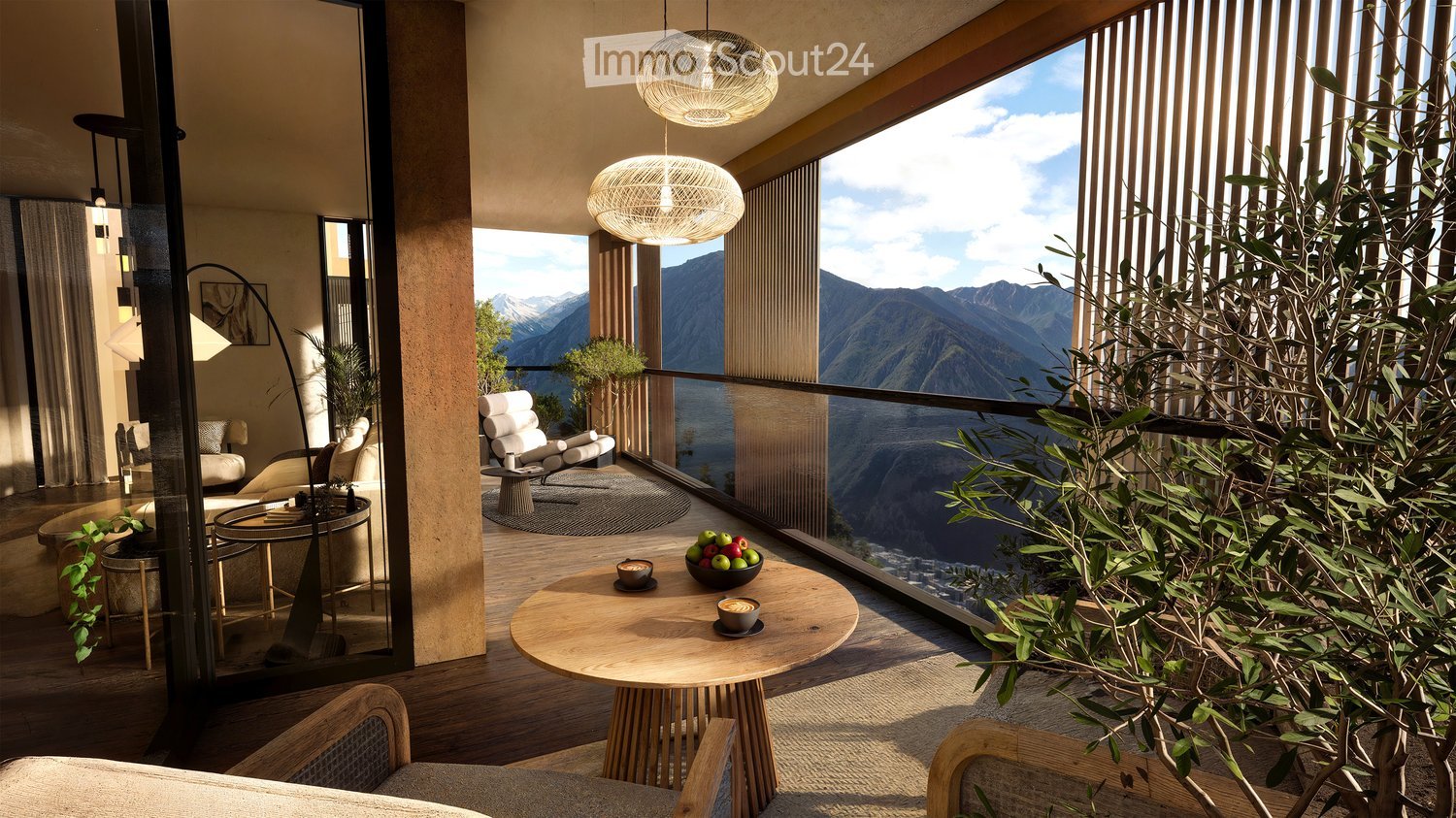 Balcony with wooden table, chairs, bowl of fruit, and a view of mountains.