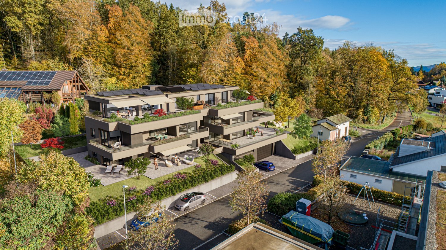 3 story apartment house, solar panels, parking area, several balconies, elevated terrain, greenery