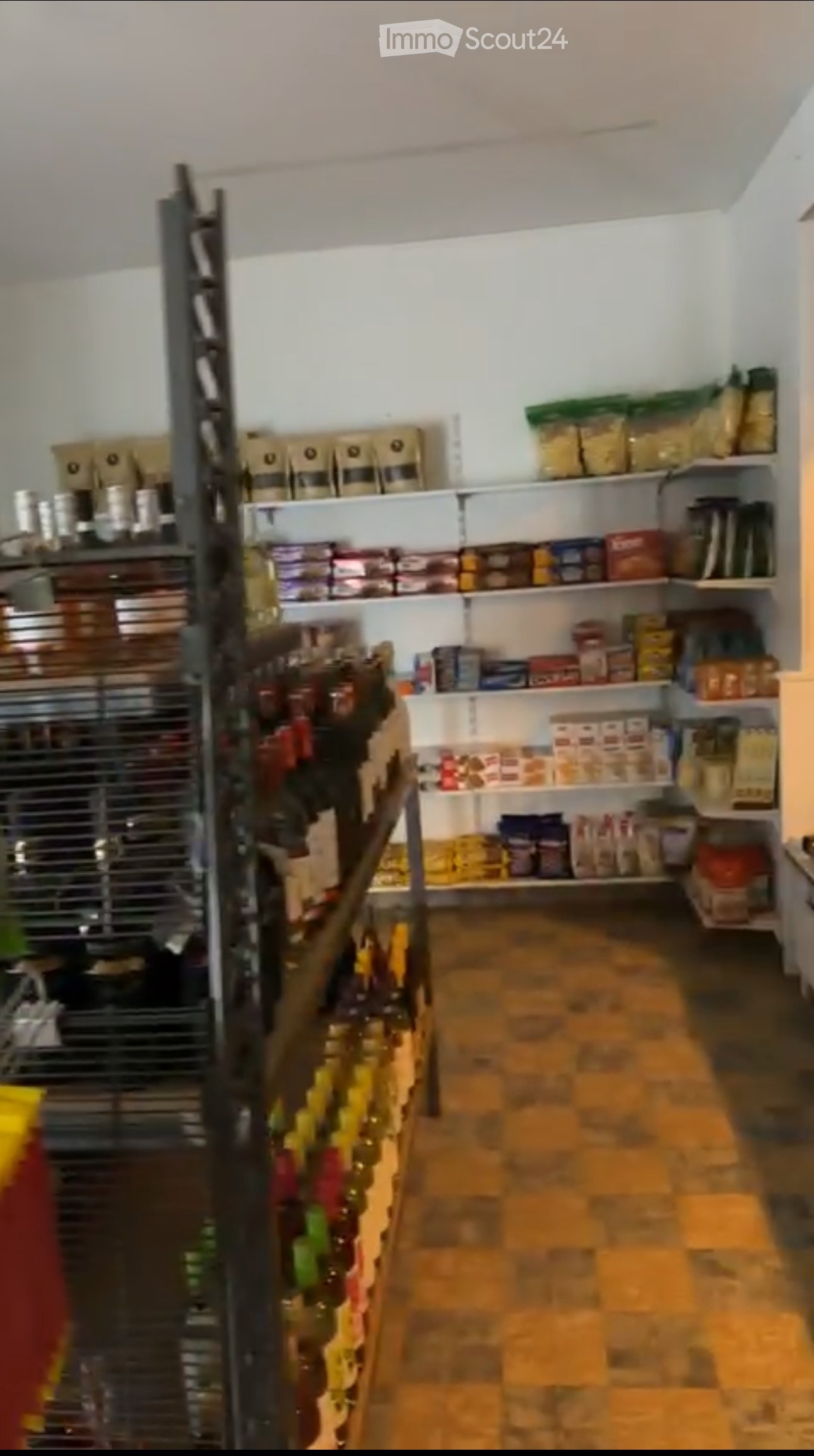 A well-stocked pantry or storage room with shelves filled with various food items and products, including bags, boxes, and bottles.