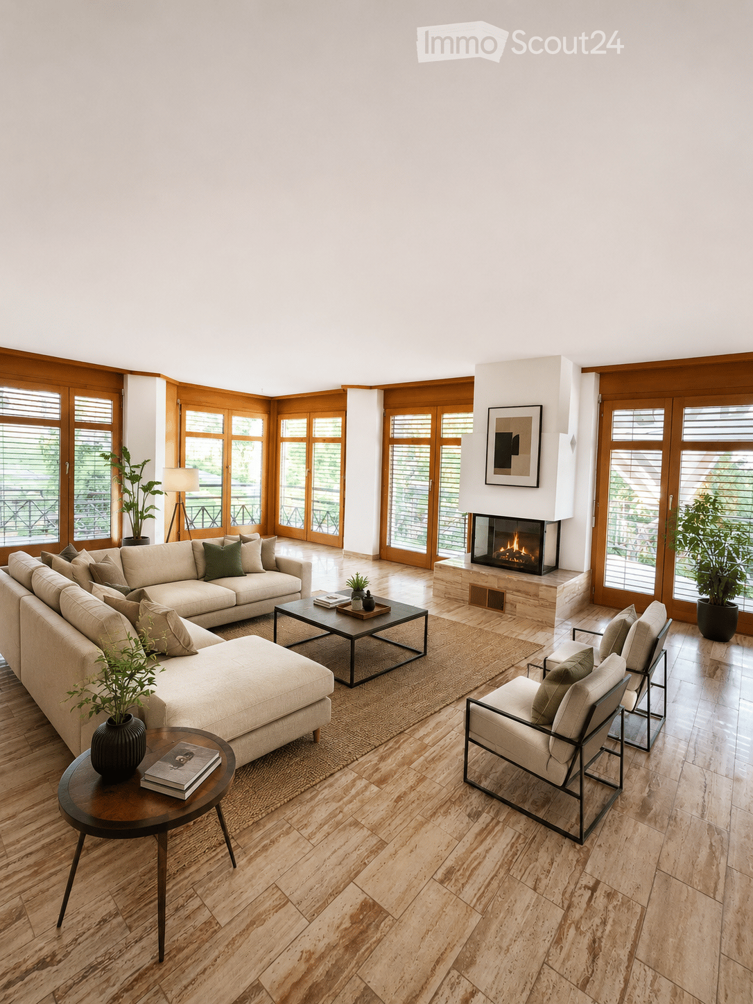 Modern living room with a large sectional sofa, coffee table, fireplace, side table, and chairs. Large windows and wooden flooring.