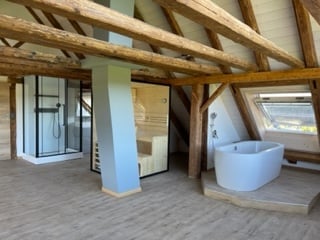 wooden beams, wooden floor, white bathtub, shower, sauna, wooden wall