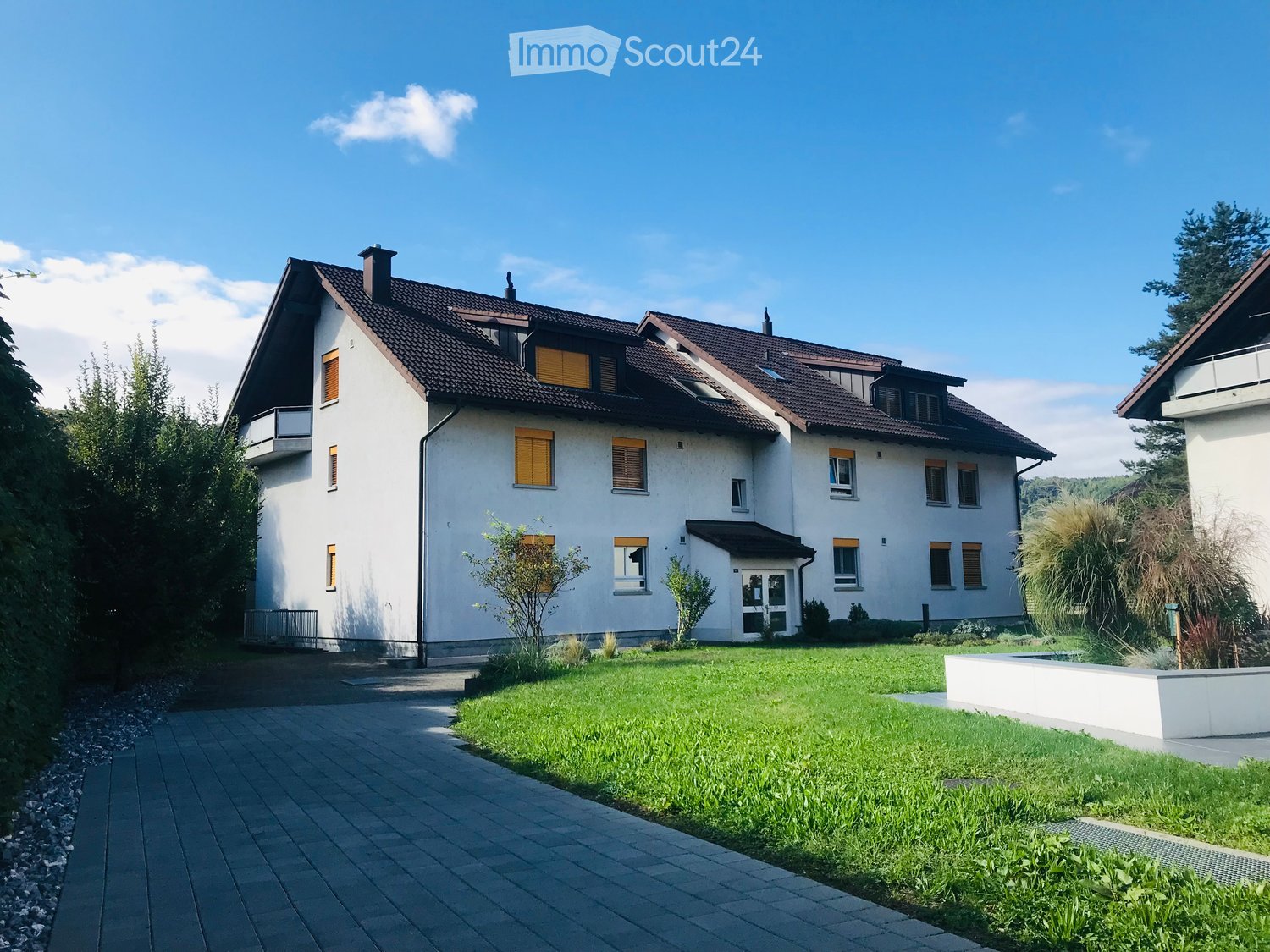 2 story house, white exterior, brown roof, yellow shutters, driveway, well-maintained lawn, plants, trees