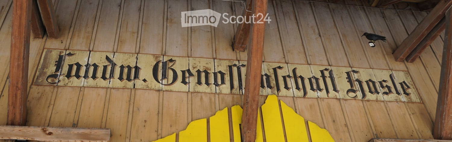 Wooden ceiling with exposed beams and a sign that reads "Lodm. Bennon Archoff H" in ornate script.