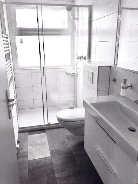small bathroom, walk in shower, white tile flooring, toilet, sink, towel rack