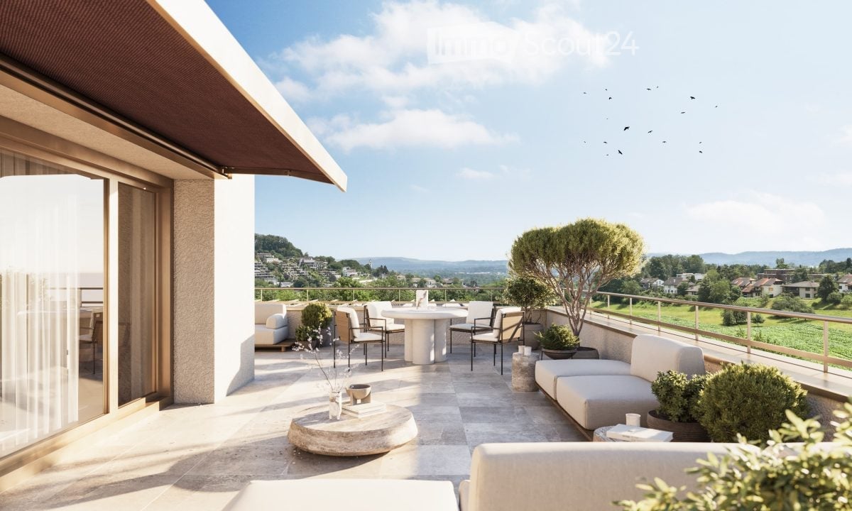 A modern rooftop terrace with white seating, round tables, and potted plants, offering a scenic view of the countryside.