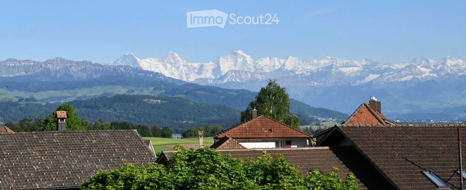 Garden area with view of the mountains and other buildings