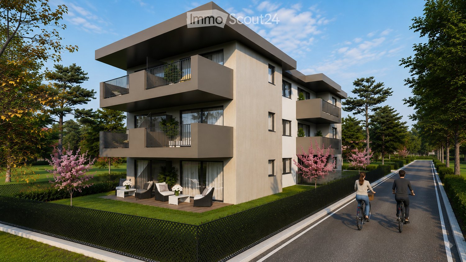 Modern multi-story residential building with balconies, surrounded by greenery and a paved pathway.