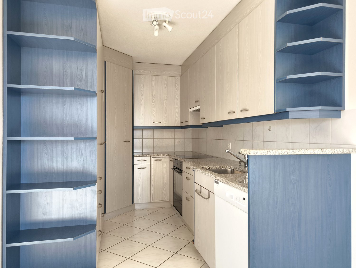 modern kitchen, white cabinets, blue shelves, granite countertop, stainless steel sink, dishwasher, washing machine, ceiling lights