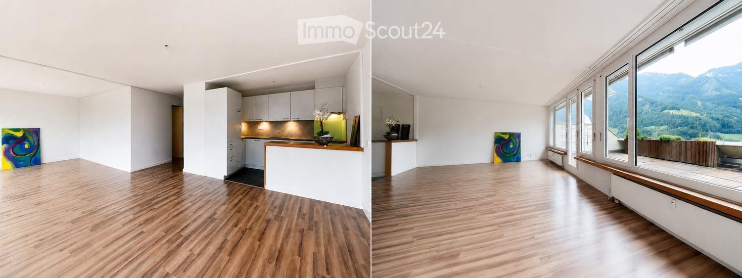 Bright, open-plan living and dining area with a modern kitchen, large windows offering a scenic mountain view, and wooden flooring.