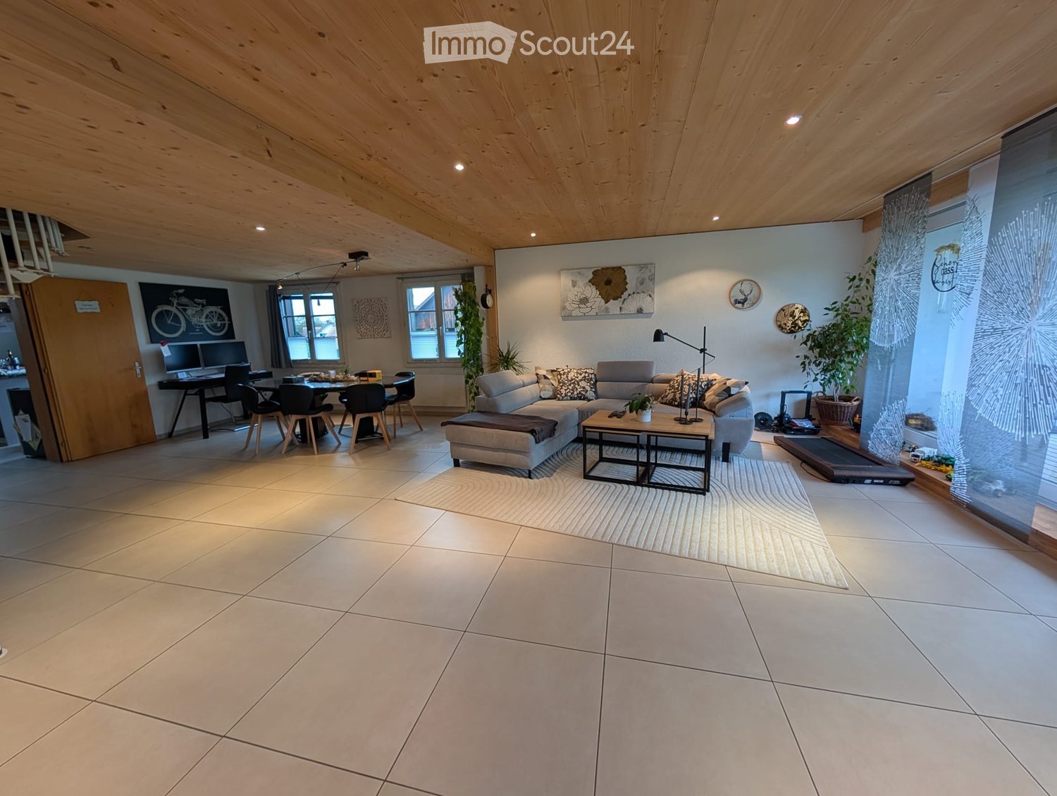 large open living space with modern furnishings and light flooring