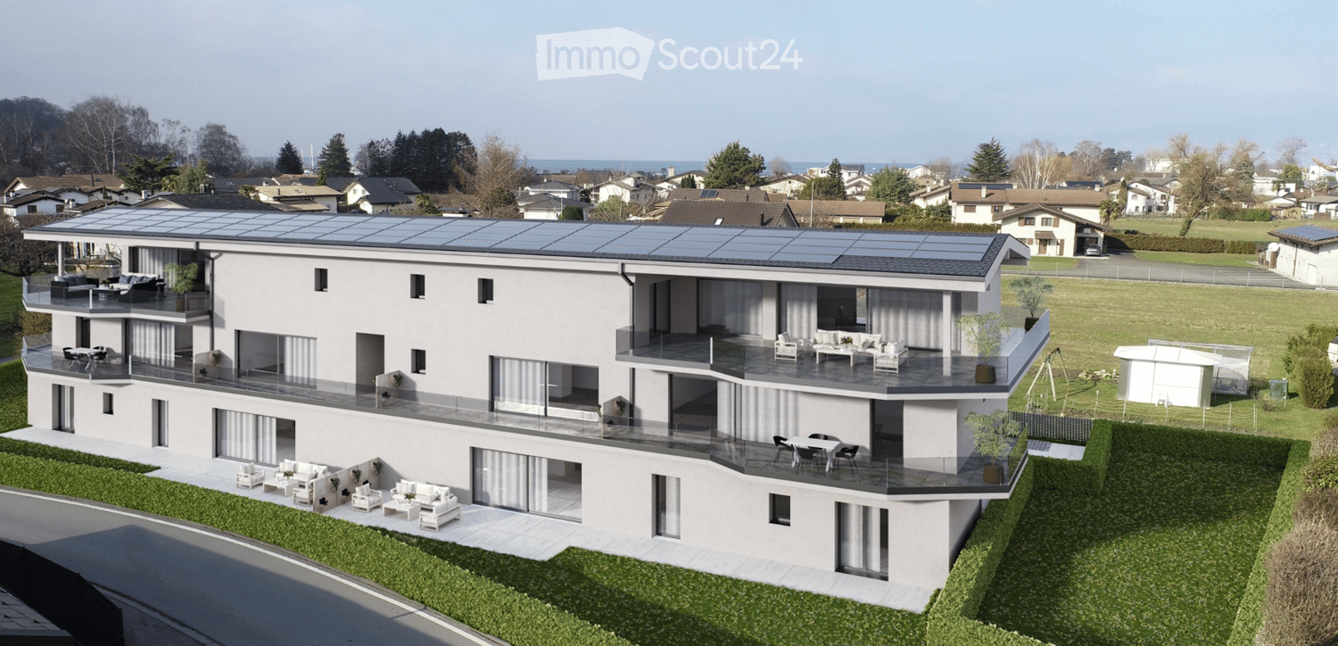 Modern two-story house with white exterior, large windows, multiple balconies, and solar panels on the roof. Outdoor seating areas are visible on the balconies and ground level.