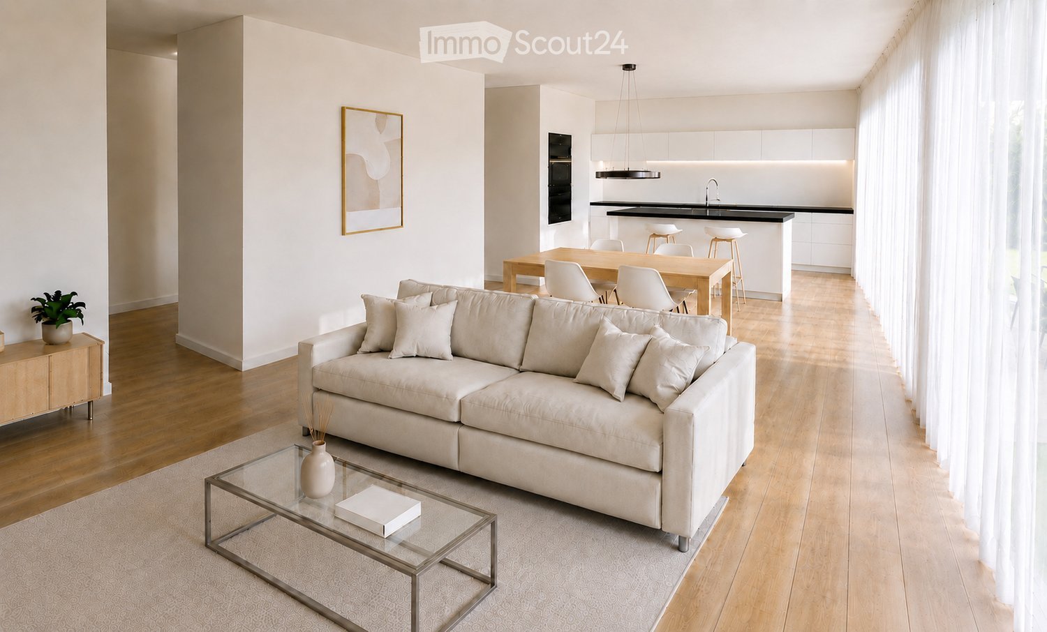 Modern living room with a light-colored sofa, glass coffee table, side table with a plant, dining area with a table and chairs, and a kitchen island with stools.