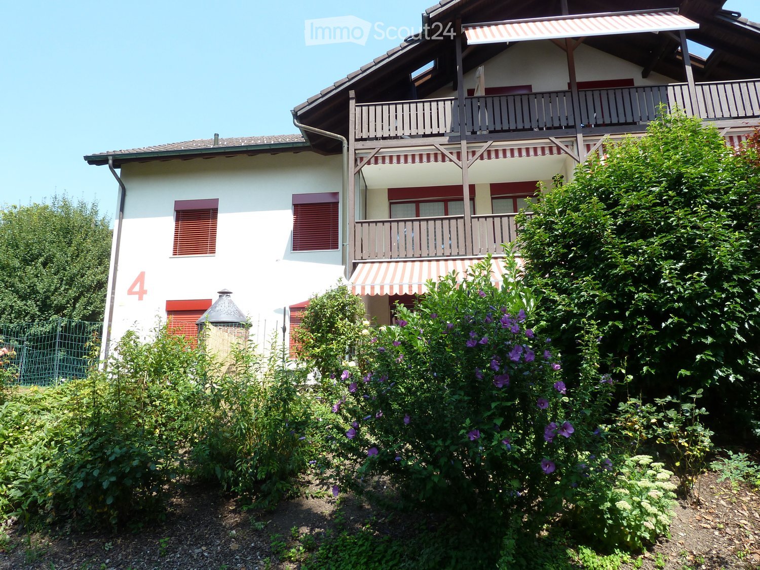 2 story house, white exterior, red shutters, balcony, red awning, garden, number 4