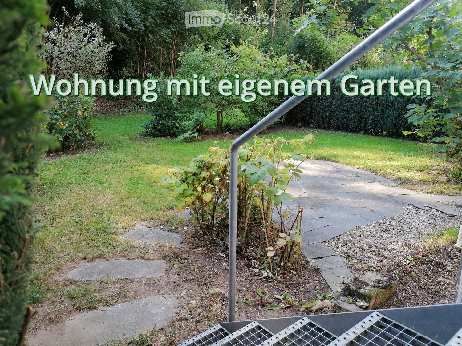 Garden with lawn, pathway, plants, bushes, stone step, railings