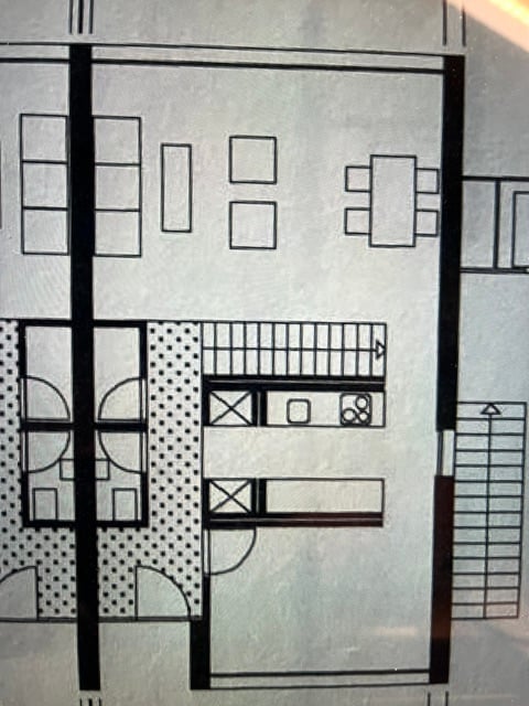 Floor plan of a multi-level building with living room, kitchen, bedrooms, bathrooms, and a balcony.