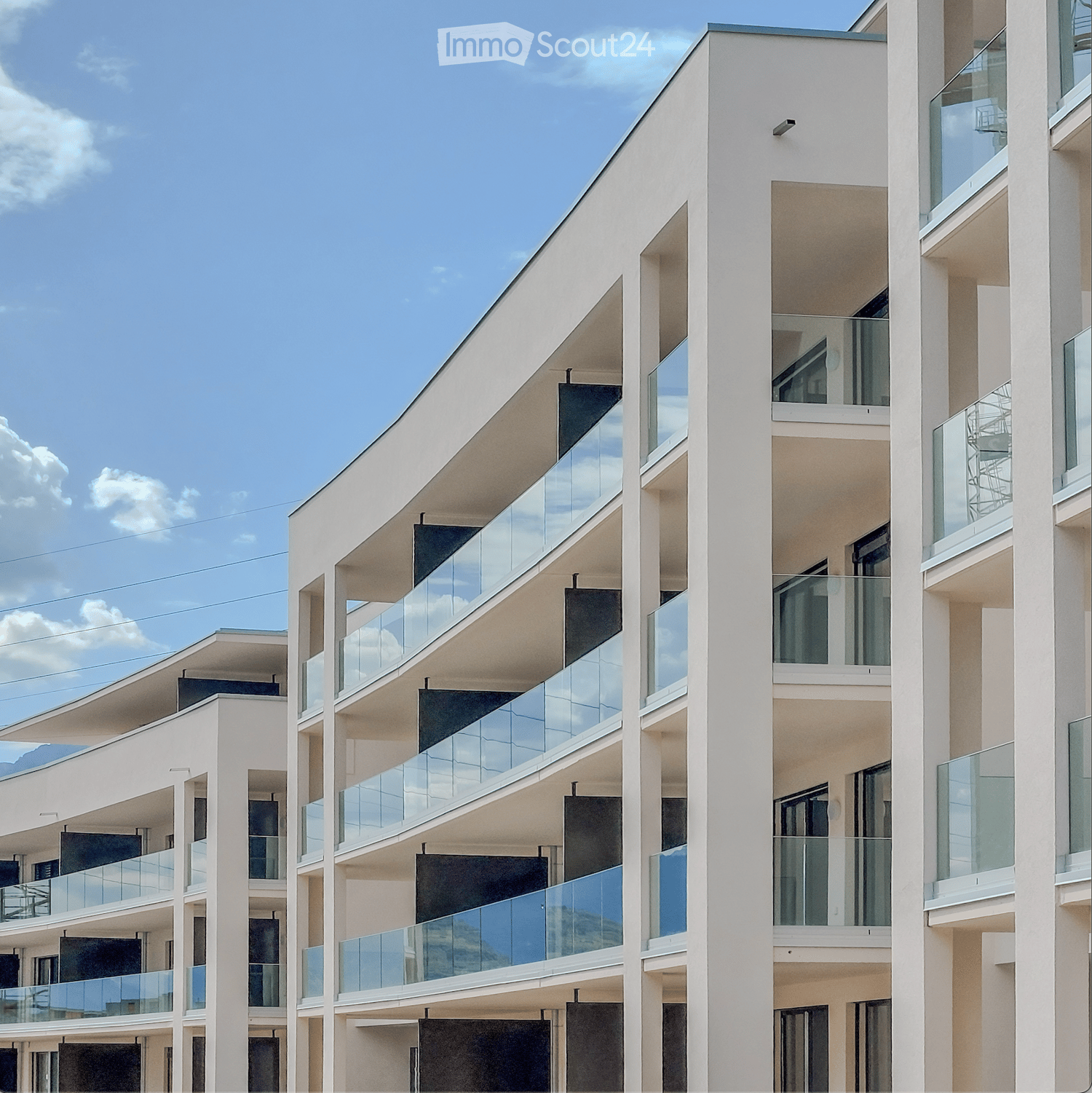 modern apartment building, multiple floors, glass balconies