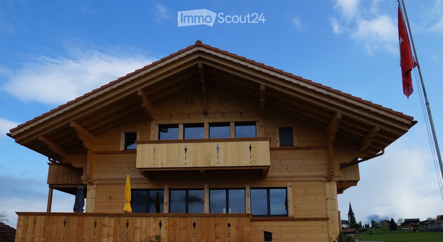wooden house, 2 stories, balcony, windows, red roof