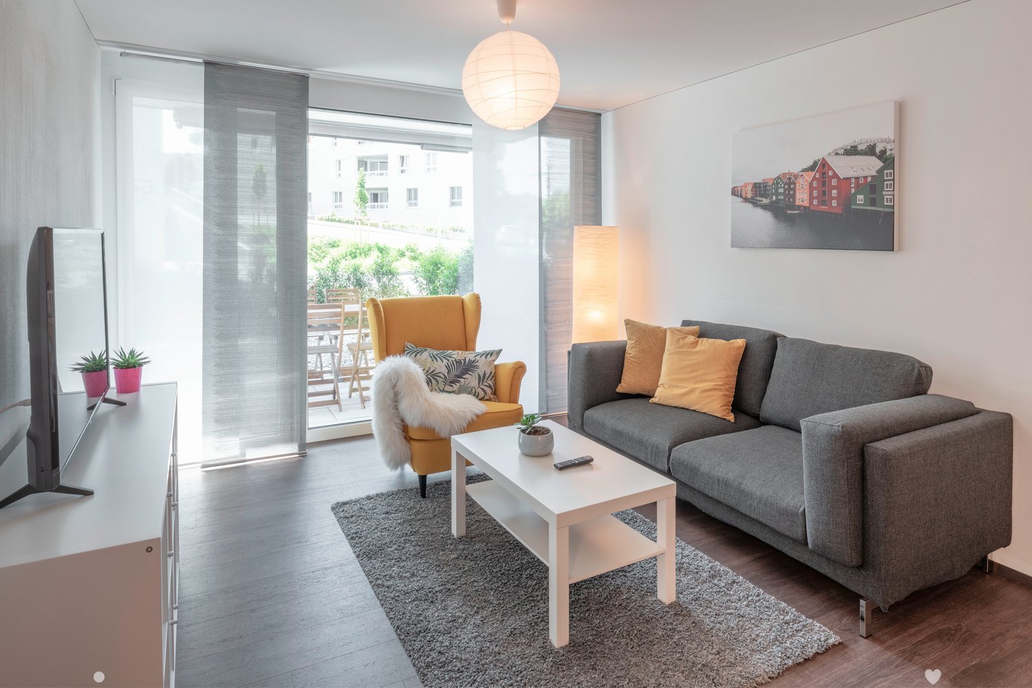 sofa, coffee table, tv, rug, yellow chair, picture frame