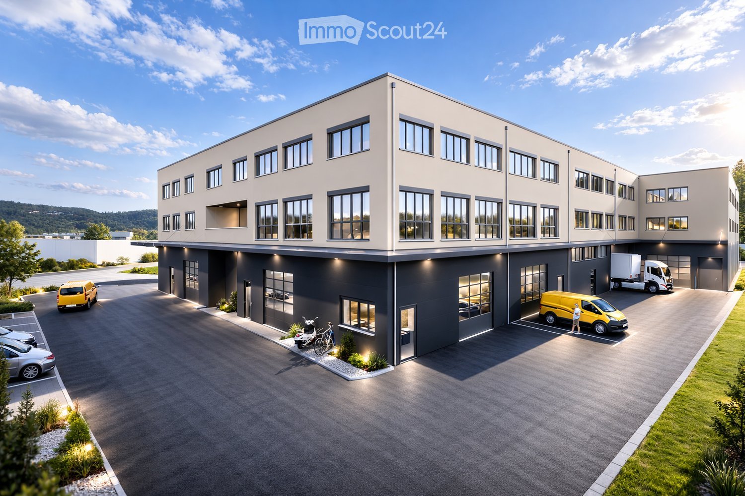 Modern two-story building with a combination of light beige and dark gray facades, large windows, and multiple parking spaces for cars and vans.