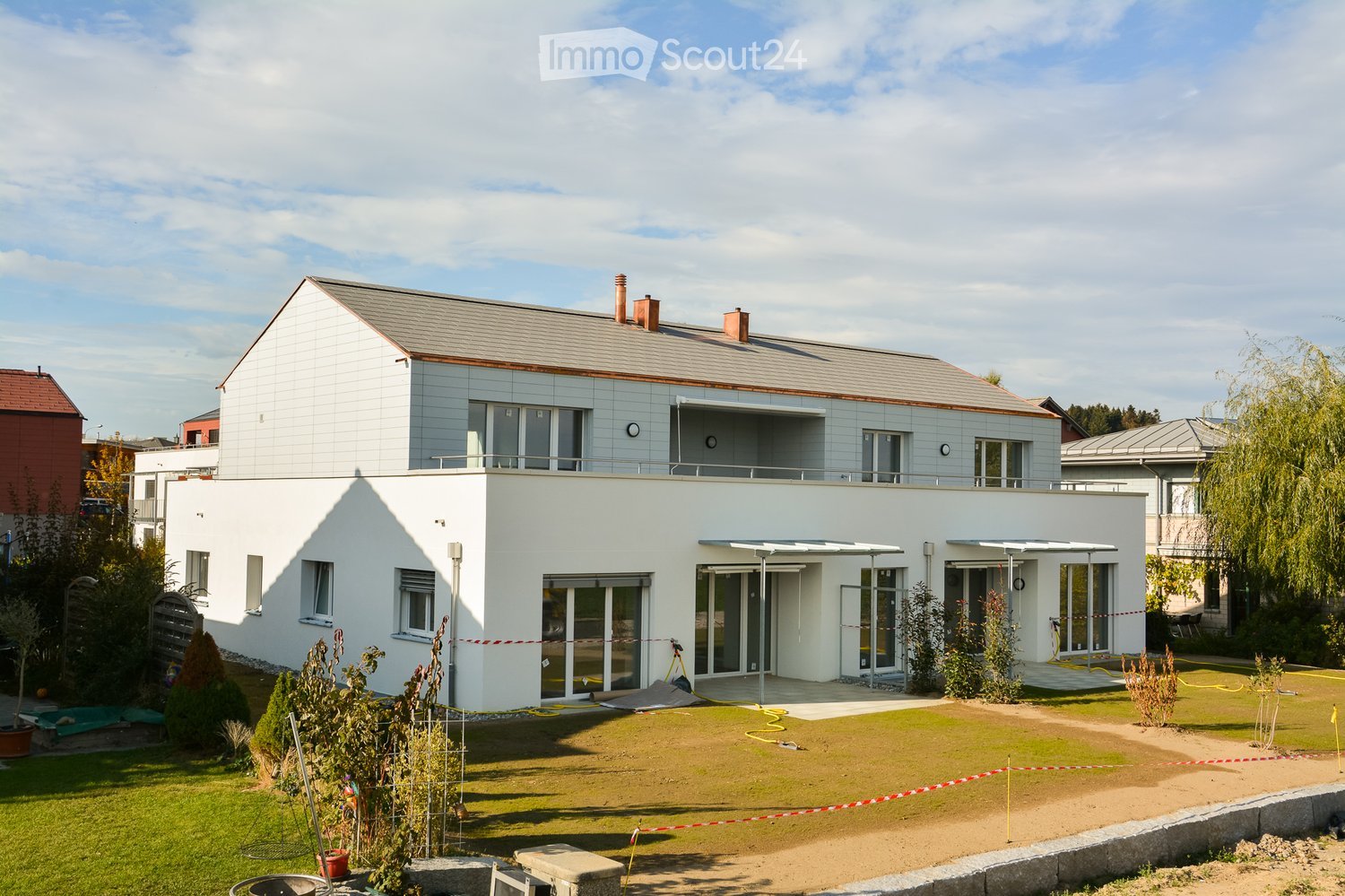 2 story house, white exterior, gray roof, large windows, balcony, garden, driveway