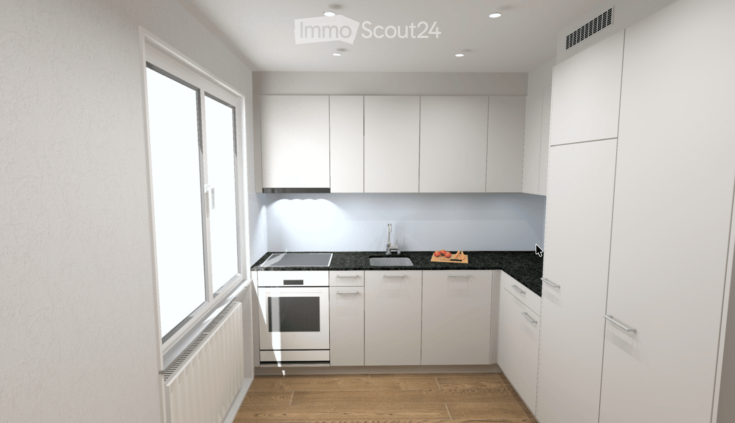 Modern kitchen with white cabinets, dark countertops, and wooden flooring. Features a sink, oven, and a small cutting board with tomatoes and carrots on the counter.